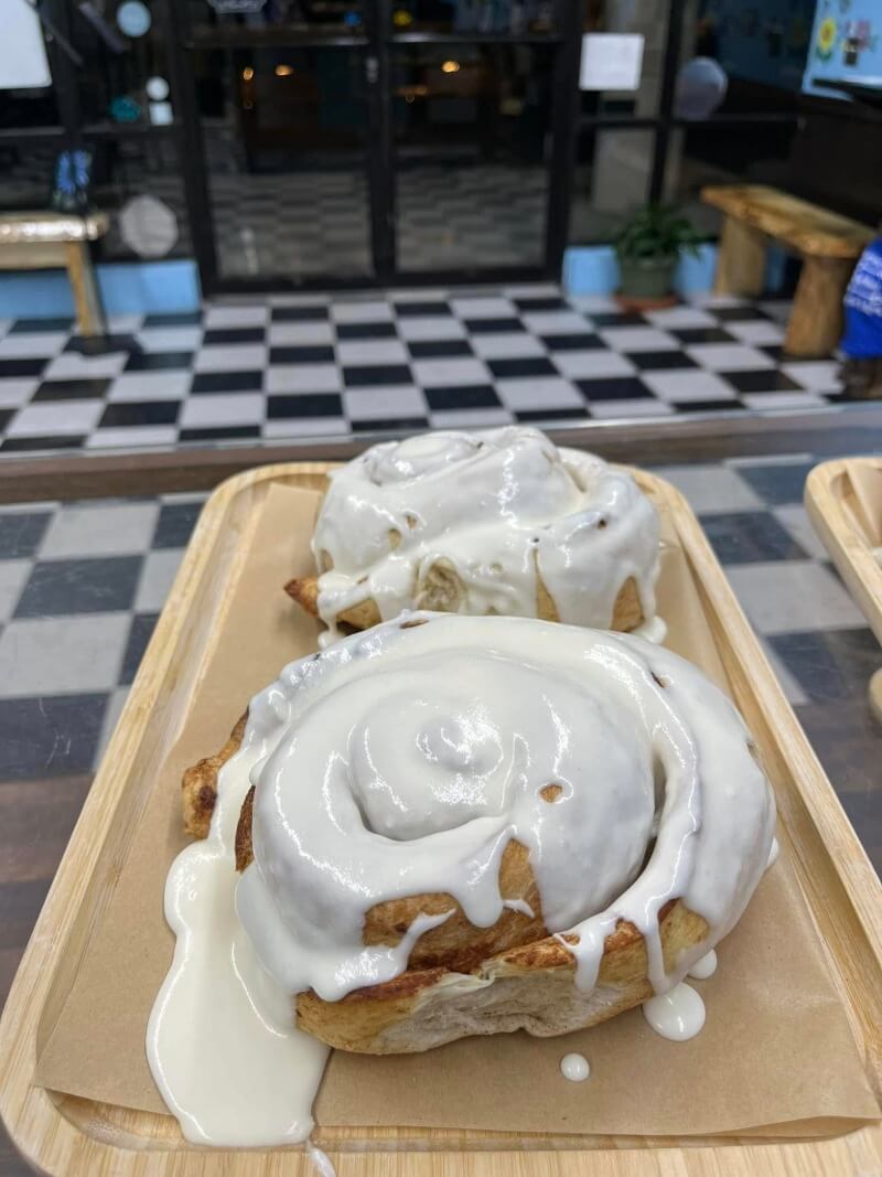 Large frosted cinnamon rolls from Kind House Ukraine Bakery.